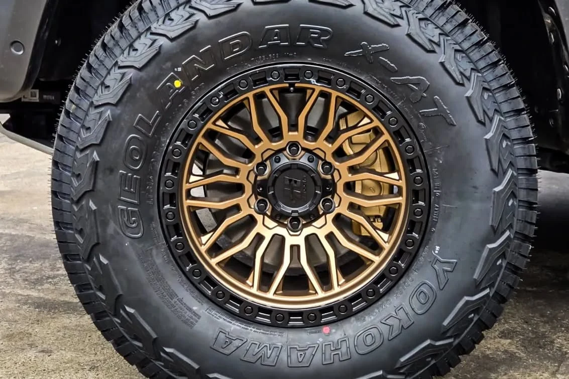 Close-up wheel detail with a bronze finish