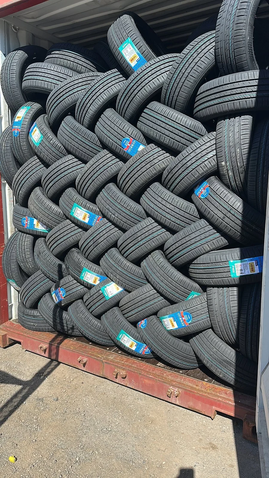 Rows of new tyres stacked inside the Rhino workshop