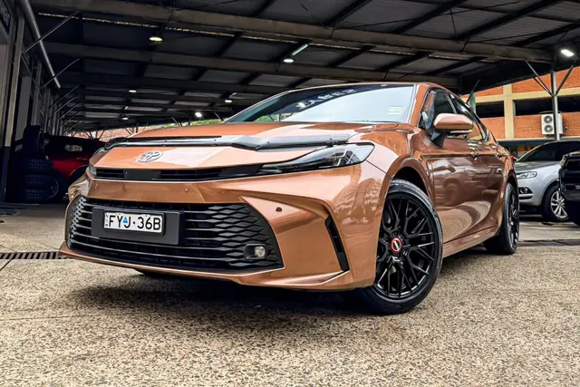 Copper-coloured Toyota Camry with black alloy wheels