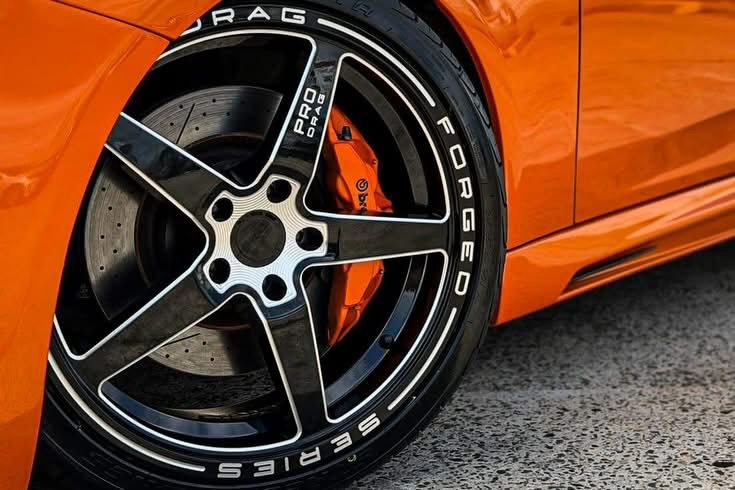 Close-up of a Pro Drag wheel and orange brake calliper