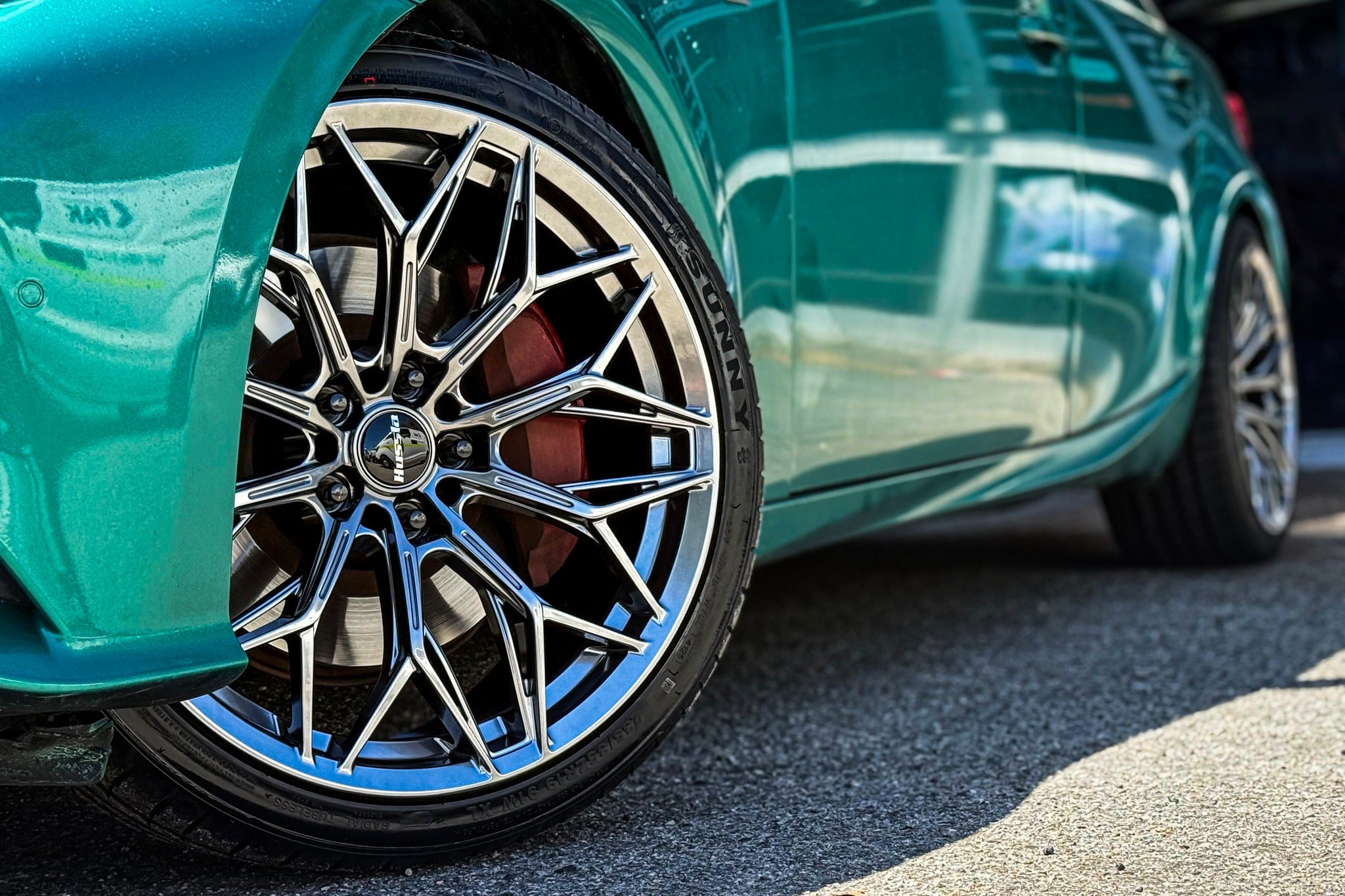 Original Rhino photo of a turquoise car with polished Hussla alloy wheels